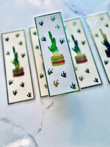 Green and pink cactus bookmark in focus with 4 other cactus bookmarks in the background