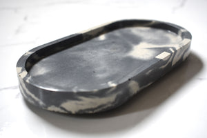 White and Gray Oval Concrete Tray at an angle on White Marble Background 